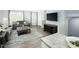 Modern living room featuring a stylish sofa, rug, and large windows, next to the kitchen at 806 Bright Nova Way, Wendell, NC 27591