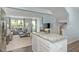 Open-concept floor plan with modern kitchen island overlooking a stylish living room and plenty of natural light at 806 Bright Nova Way, Wendell, NC 27591