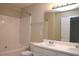 Bright bathroom with a double sink vanity, soaking tub, and a white tiled surround at 8511 Bright Loop, Raleigh, NC 27613