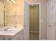 Bright bathroom featuring a double vanity, large mirror and closet at 8511 Bright Loop, Raleigh, NC 27613