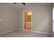 Spacious bedroom with carpet flooring and an open doorway to the ensuite bathroom at 8511 Bright Loop, Raleigh, NC 27613