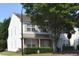 Charming two-story townhome with white siding, neutral shutters, well-maintained landscaping, and mature trees at 8511 Bright Loop, Raleigh, NC 27613