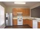 Spacious kitchen featuring wood cabinets, modern appliances, and sleek countertops, providing ample cooking space at 8511 Bright Loop, Raleigh, NC 27613