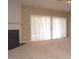 Spacious living room with fireplace and large window with bright light shining through white curtains at 8511 Bright Loop, Raleigh, NC 27613
