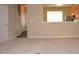 Cozy living room featuring a partial view into kitchen, neutral color palette and carpet flooring at 8511 Bright Loop, Raleigh, NC 27613