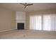 Spacious living room with a fireplace, soft carpeting, neutral walls, and large windows covered with white curtains at 8511 Bright Loop, Raleigh, NC 27613