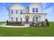 Beautiful two-story home with a welcoming front porch, stone accents, and lush landscaping at 194 Charlotte Knoll St # 10, Zebulon, NC 27597