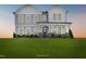 Charming two-story home featuring a covered front porch with stone accents and a well-manicured lawn at 194 Charlotte Knoll St # 10, Zebulon, NC 27597