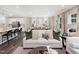 Bright living room with a neutral color palette, connected to the kitchen and dining area at 1000 Sora Way, Durham, NC 27703