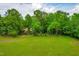 Aerial view of a home surrounded by lush greenery and a large, grassy yard at 101 Easton Ct, Garner, NC 27529