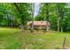 Picture of the backyard and house with an expanse of green lawn and lots of trees at 101 Easton Ct, Garner, NC 27529