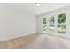 Bright bedroom with neutral carpet, white walls, base trim, and three large windows offering lots of natural light at 101 Easton Ct, Garner, NC 27529