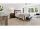 Bright and airy bedroom with large windows, neutral decor, and plush carpet at 101 Easton Ct, Garner, NC 27529