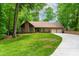 Lovely brick home featuring a well-manicured lawn, mature trees, and a spacious driveway leading to the garage at 101 Easton Ct, Garner, NC 27529