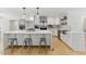 Modern kitchen with white cabinets, stainless steel appliances, a large center island, and pendant lighting at 101 Easton Ct, Garner, NC 27529