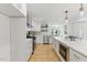 A sleek white kitchen with stainless steel appliances and modern cabinetry at 101 Easton Ct, Garner, NC 27529