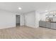 Open living area with wood-look floors, neutral paint, and a kitchenette at 101 Easton Ct, Garner, NC 27529