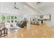 Bright, open-concept living room featuring a vaulted ceiling, hardwood floors, and seamless flow to the kitchen at 101 Easton Ct, Garner, NC 27529