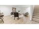 Spacious living room with wood-look floors, neutral paint, modern furniture, and a carpeted staircase at 101 Easton Ct, Garner, NC 27529