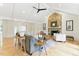 Warm and cozy living room featuring a stone fireplace, vaulted ceiling, and hardwood floors, perfect for relaxation at 101 Easton Ct, Garner, NC 27529