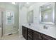 Bathroom featuring a double sink vanity, shower with glass door, and light green walls at 1013 Oatney Ridge Ln, Morrisville, NC 27560