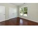 Empty bedroom with hardwood floors, double-door closet, and bright window views at 1013 Oatney Ridge Ln, Morrisville, NC 27560