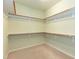 Walk-in closet with carpeted floor, wooden rods and adjustable shelving with neutral walls at 1013 Oatney Ridge Ln, Morrisville, NC 27560