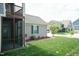 Well-maintained home with lush green lawn, mature landscaping, and charming screened-in porch at 1013 Oatney Ridge Ln, Morrisville, NC 27560