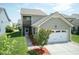 Charming home features a 2 car garage, balcony, screened-in porch, and well-manicured lawn at 1013 Oatney Ridge Ln, Morrisville, NC 27560