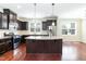 Updated kitchen features stainless steel appliances, granite countertops, and central island at 1013 Oatney Ridge Ln, Morrisville, NC 27560