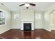 Cozy living room with fireplace, ceiling fan, and bright windows overlooking the front yard at 1013 Oatney Ridge Ln, Morrisville, NC 27560