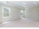 Empty main bedroom with carpet floors, bright lighting, and crown molding at 1013 Oatney Ridge Ln, Morrisville, NC 27560