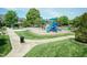 Community playground with slides, swings, picnic tables and mature trees at 1013 Oatney Ridge Ln, Morrisville, NC 27560