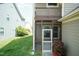 Screened porch with white gate offers a cozy entrance and a view of the outdoor space at 1013 Oatney Ridge Ln, Morrisville, NC 27560
