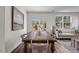 Dining area with wooden table set for a meal, blending seamlessly with the living space at 106 S Chubb Rdg, Wilson's Mills, NC 27520