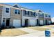 Attractive townhomes featuring attached garages, neutral color schemes, and landscaping throughout the community at 106 S Chubb Rdg, Wilson's Mills, NC 27520