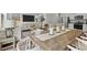 Open-concept living space with a dining table, stainless steel appliances, and a cozy seating area at 106 S Chubb Rdg, Wilson's Mills, NC 27520