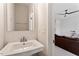 Stylish powder room with a modern sink, chrome fixtures, and convenient access from the living area at 1073 Branch Line Ln, Apex, NC 27502