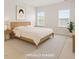 Staged primary bedroom with a bed, two windows and minimalist decor at 1073 Branch Line Ln, Apex, NC 27502