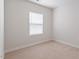 Neutral bedroom featuring carpet flooring and a large window for natural light at 1073 Branch Line Ln, Apex, NC 27502