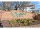 Landscaped community sign with yellow and purple flowers at The Villages of Apex at 1073 Branch Line Ln, Apex, NC 27502