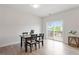 Dining area with a wooden table and chairs next to a sliding glass door at 1073 Branch Line Ln, Apex, NC 27502