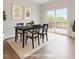 Staged dining room featuring modern decor and a sliding glass door leading to an outdoor space at 1073 Branch Line Ln, Apex, NC 27502