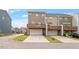 Townhome exterior with drive-under garage and outdoor patio at 1073 Branch Line Ln, Apex, NC 27502