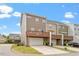 Townhome exterior with a drive-under garage and covered patio at 1073 Branch Line Ln, Apex, NC 27502