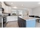 Well-lit kitchen with stainless steel appliances, granite countertops, an island, and an adjacent dining area at 1073 Branch Line Ln, Apex, NC 27502