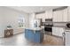 Bright kitchen features white cabinets, stainless steel appliances, granite countertops, and a contrasting kitchen island at 1073 Branch Line Ln, Apex, NC 27502