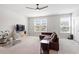 Spacious living room with ample natural light, neutral carpet, and views of the outdoors through large windows at 1073 Branch Line Ln, Apex, NC 27502