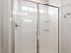 Bright shower featuring white tiling and glass sliding door at 1073 Branch Line Ln, Apex, NC 27502