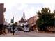 Picturesque street view showcasing local businesses, sidewalks, and a historic church steeple at 1073 Branch Line Ln, Apex, NC 27502